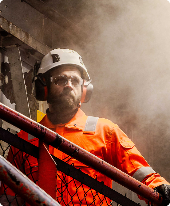 Worker in full PPE in a dusty industrial environment