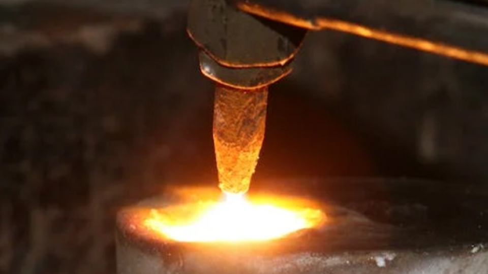 Close-up of a hot work torch applying intense heat to metal