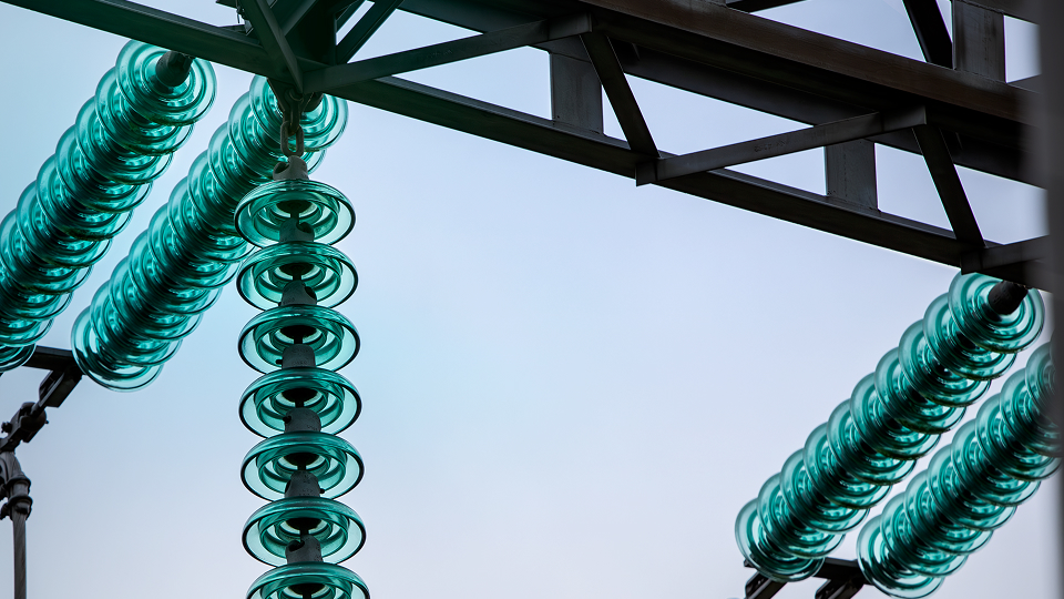 close-up of high-voltage insulators on a power line structure